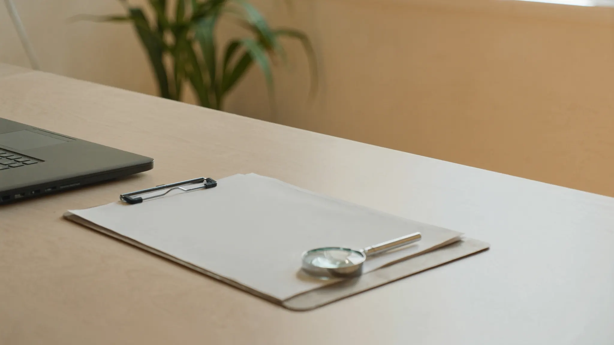 Your marketing situation, bright desk with a closed notebook and a magnifying glass lying flat
