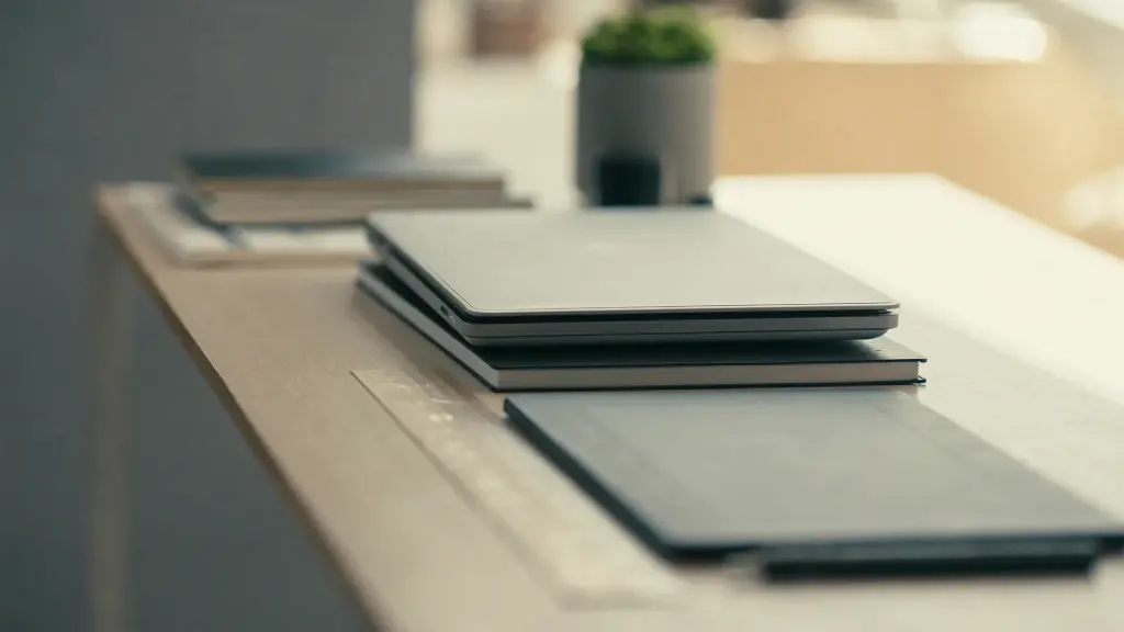 desk with stacked devices and a graphics tablet