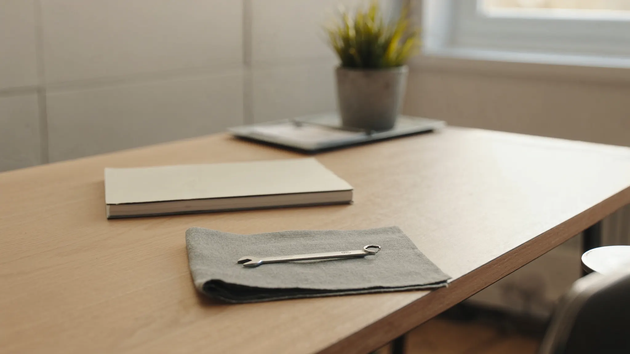 WordPress maintenance, desk with a wrench and a closed notebook