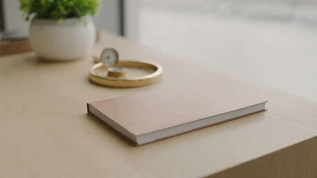 desk with a brass compass and a closed notebook