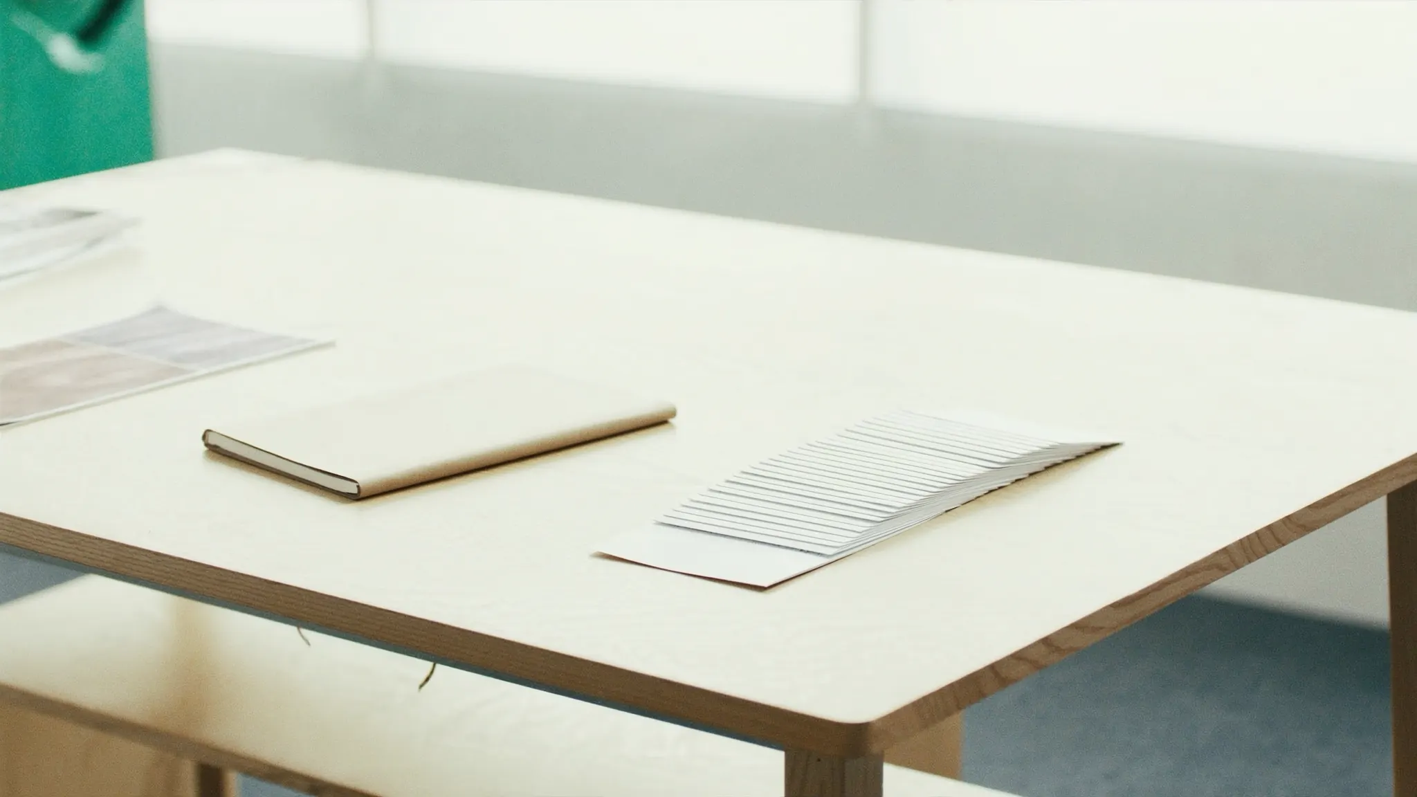 Landing pages, desk with a closed notebook and fanned blank cards