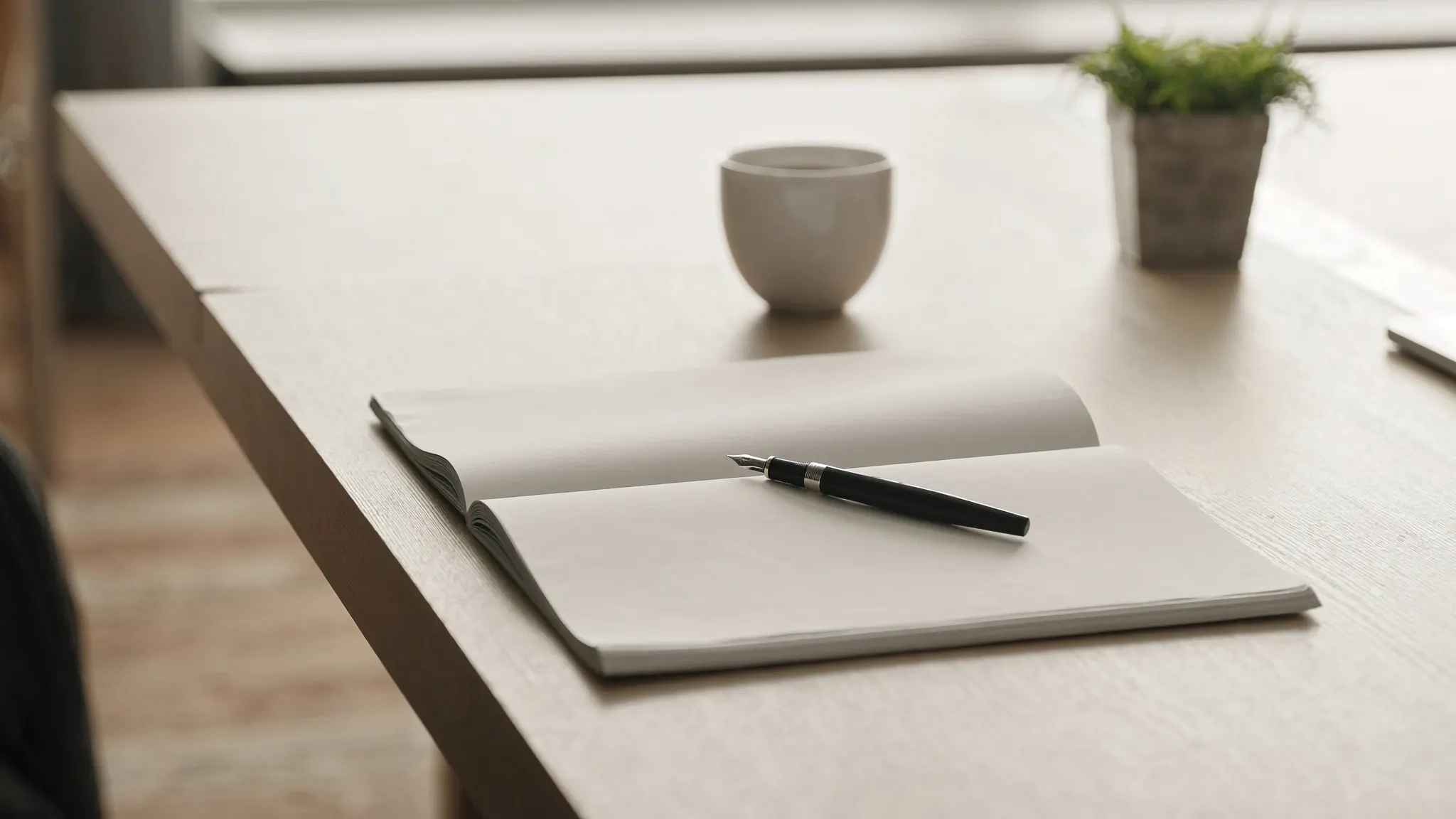 Frequently asked questions about digital marketing, writing desk with an open notebook and a pen resting on it