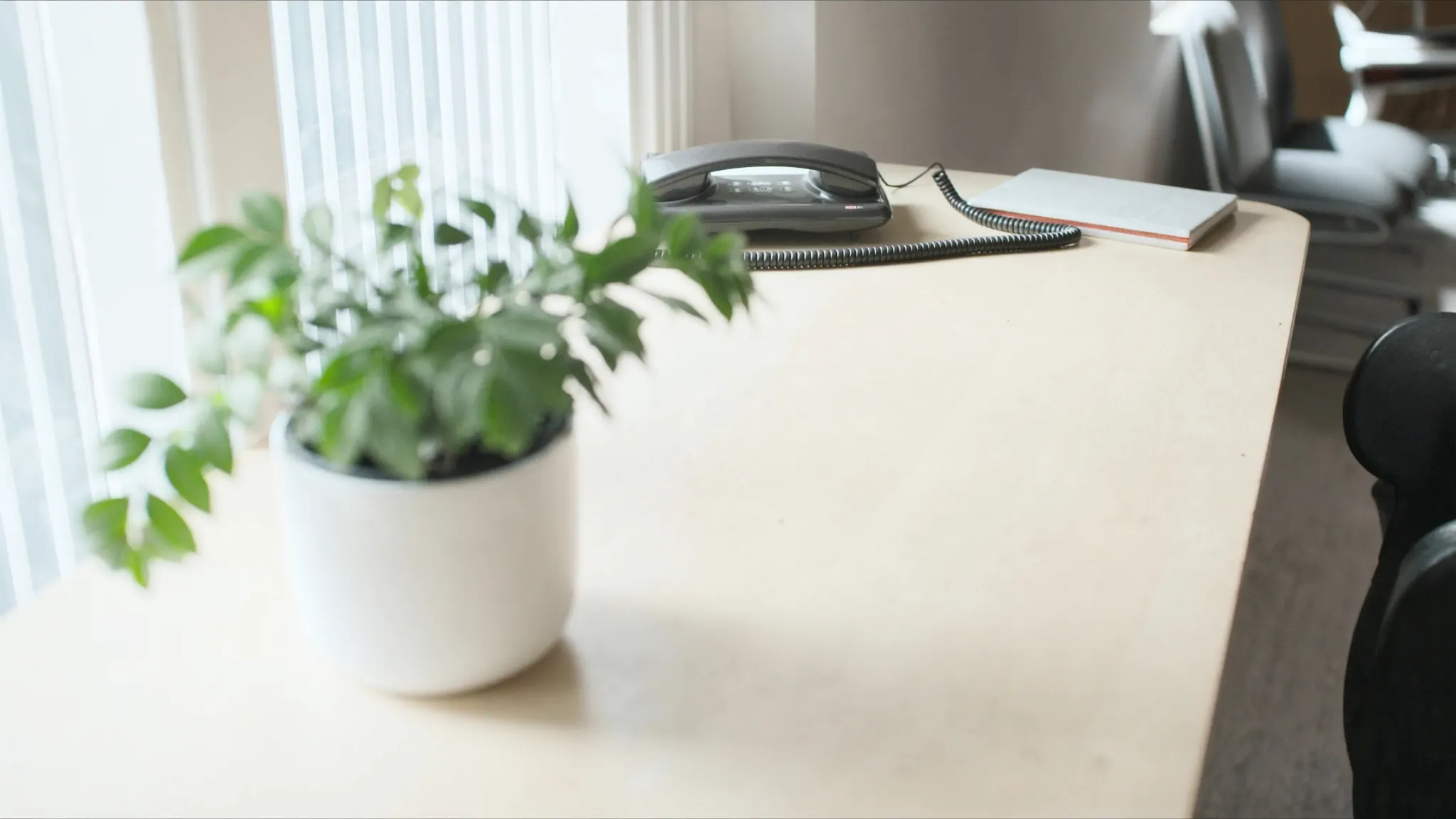 High Bounce Rate, desk with a handset resting in its cradle and a closed notebook