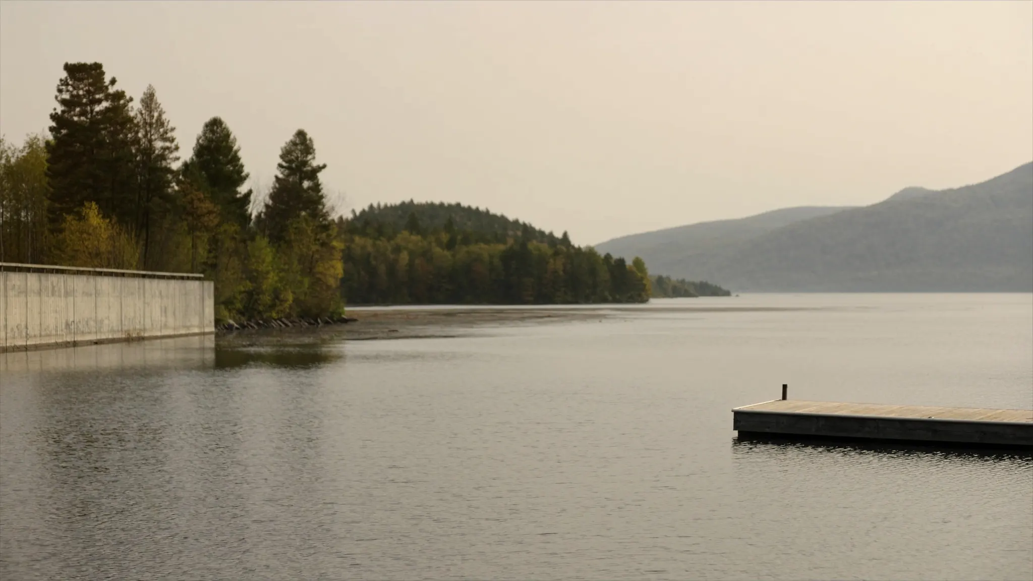 Laurentians, marketing agency, calm mountain lake with a wooden dock
