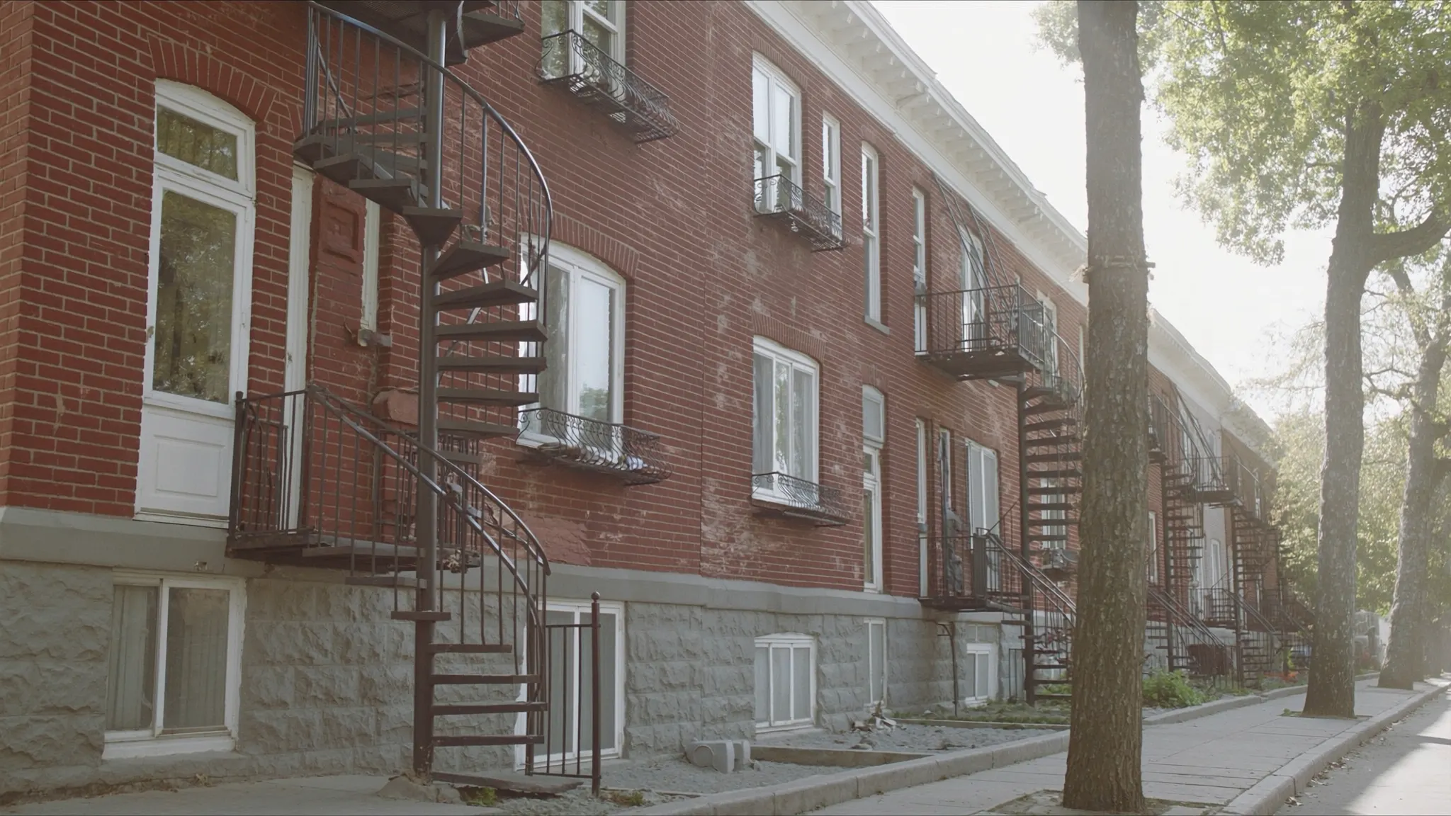 Montreal, marketing agency, brick rowhouses in the Plateau neighbourhood with wrought-iron spiral exterior staircases